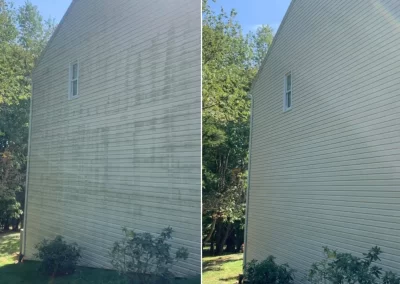 Side-by-side view of a house exterior before and after being cleaned, with stains removed on the right.